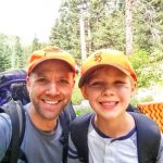 Photo of son and father backpacking