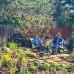 Photo of Leigh and Eric Houston relax in front lawn that is xeriscaped.