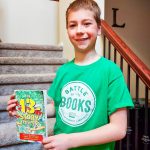 fourth grader Matthew Liepen holds one of his favorite reads