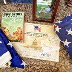 Photo of Michael Conner's Boy Scout handbook and other memorabilia.