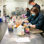 Photo of ProStart students working in the culinary lab kitchen at ThunderRidge High School.