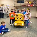 Photo of Robotic Buster the Bus interacts with students