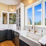 Photo of large windows that capture the beautiful trees and mountain views outside.